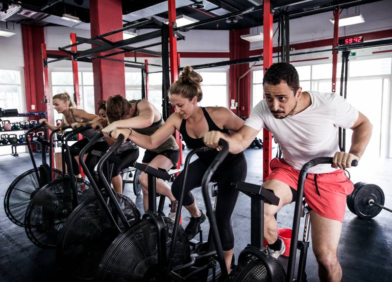 Muscular athletes training in a crossfit gym - Functional training workout in a gym